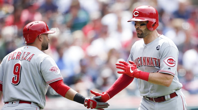 CLEVELAND, OH - JUNE 12: Curt Casali #12 of the Cincinnati Reds celebrates with Jose Peraza #9 after hitting a solo home run off Nick Goody #44 of the Cleveland Indians during the seventh inning at Progressive Field on June 12, 2019 in Cleveland, Ohio. (Photo by Ron Schwane/Getty Images)