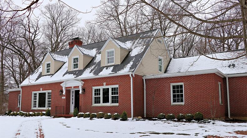 Built in 1950, the Cape Cod house has updated and refinished hardwood floors with peg-nail accents, built-in cabinetry, window cornices, wainscoting, and skeleton-key brass lock blocks on entry doors.