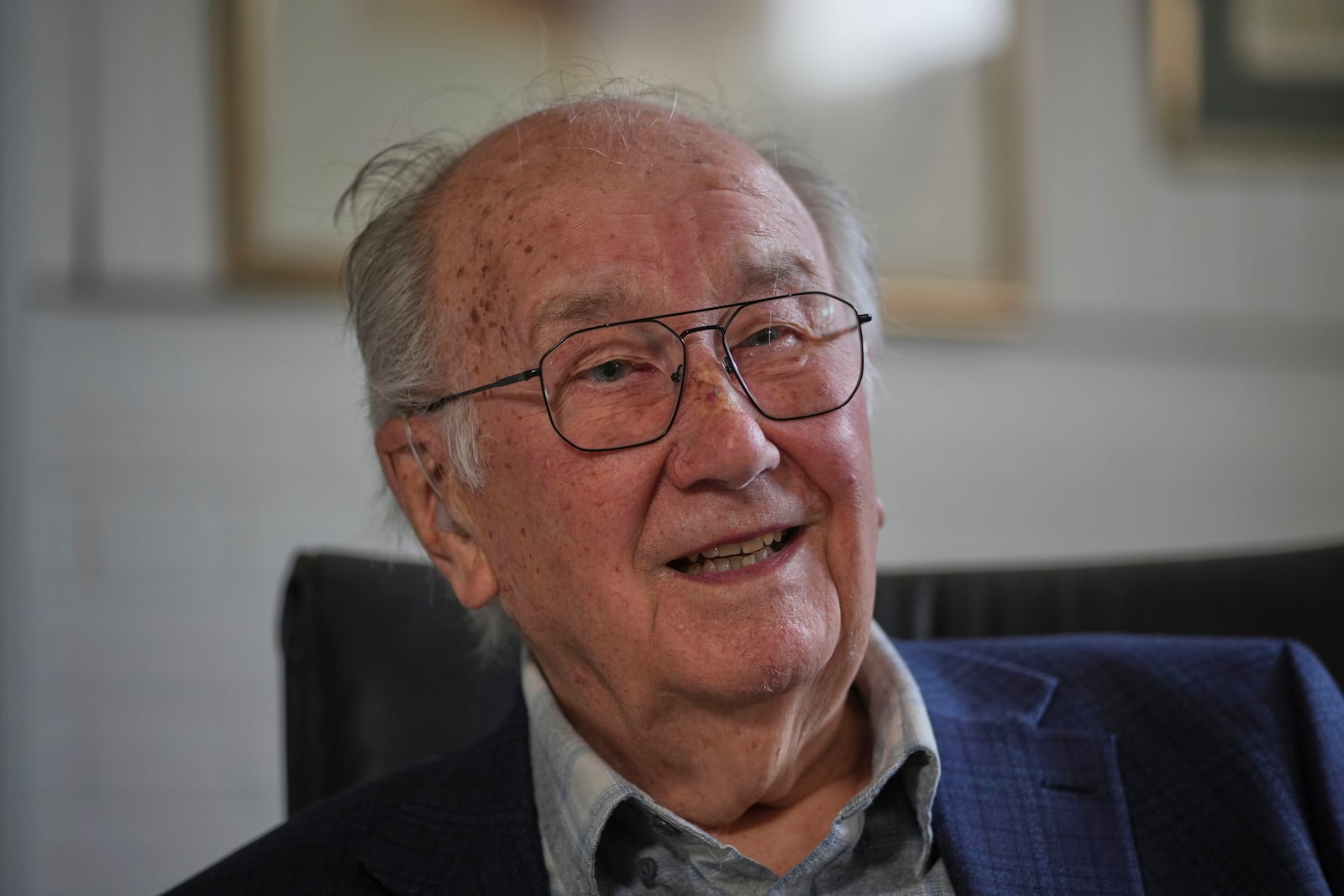 John Goldsmith, 94, draws during an interview at his home in London, Thursday, April 24, 2025. (AP Photo/Kin Cheung)