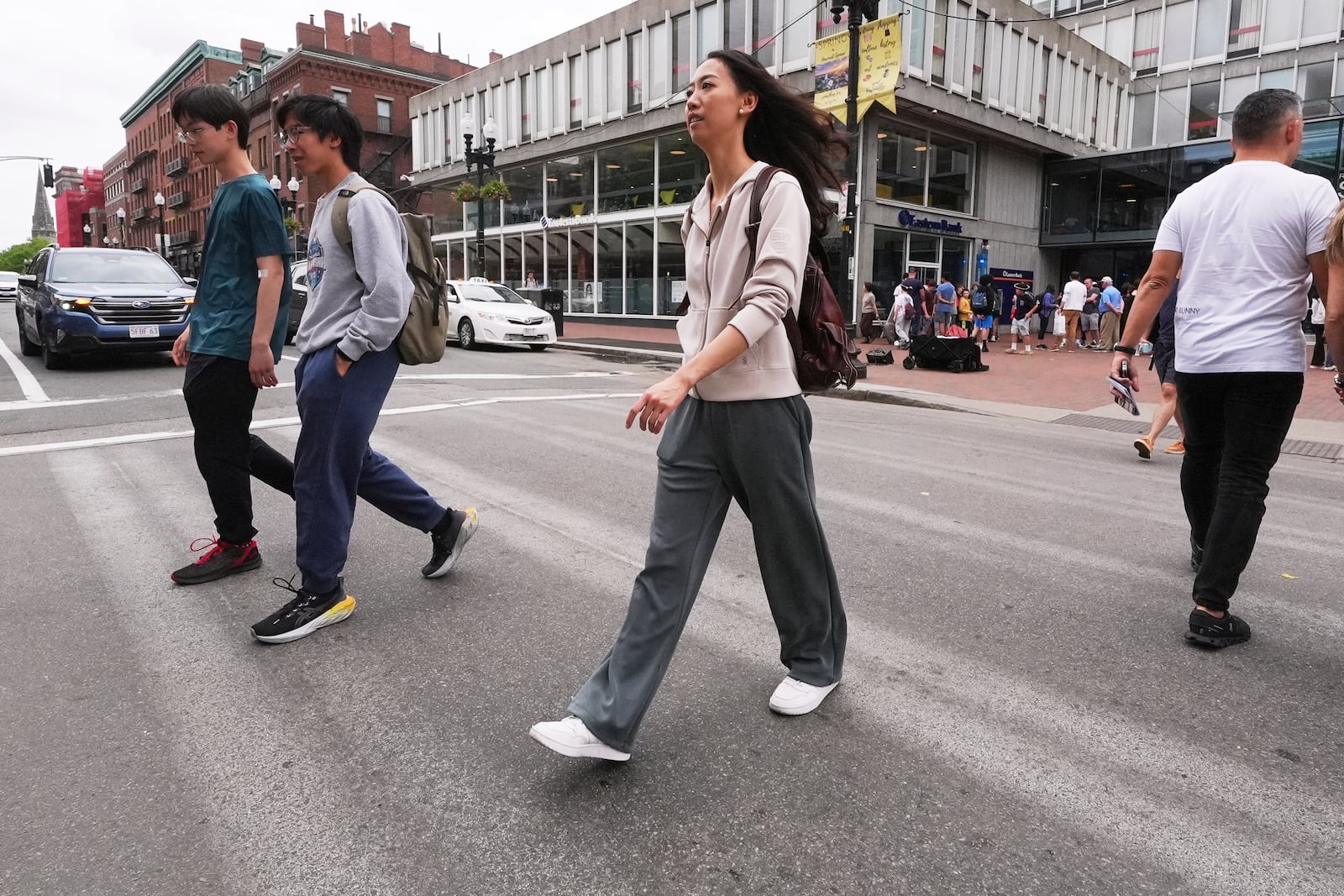 Yurong "Luanna" Jiang, who delivered a speech at her Harvard University commencement, crosses Massachusetts Avenue near the gates of Harvard Yard, Friday, May 30, 2025, in Cambridge, Mass. (AP Photo/Charles Krupa)