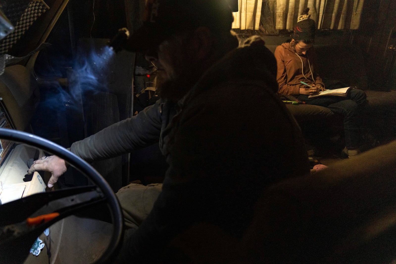 Chris Daggett works to get an RV to start so that it can be moved at a homeless encampment in Deschutes National Forest Wednesday, April 30, 2025 near Bend, Ore. (AP Photo/Jenny Kane)