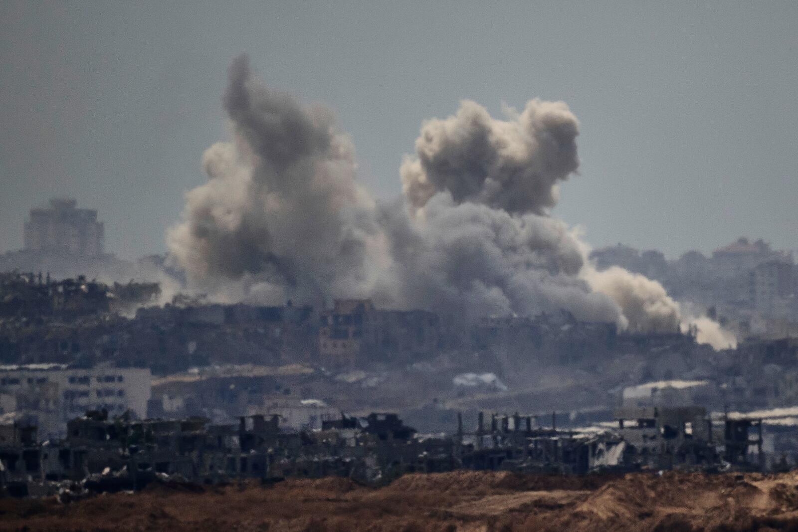 Smoke rises to the sky after an explosion in the Gaza Strip as seen from Sderot, southern Israel, Thursday, May 22, 2025. (AP Photo/Leo Correa)