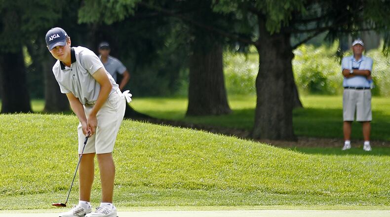 Luke Wells, a 16-year-old Springfield High School student, watches his putt roll across the third green during the second round of the Ohio Amateur at the Springfield Country Club on Wednesday. BILL LACKEY / STAFF