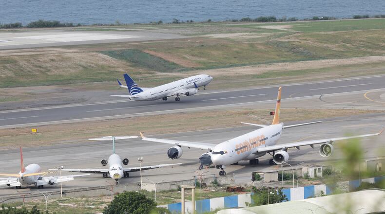 A COPA Airlines plane takes off at Simon Bolivar International Airport in Maiquetia, Venezuela, Monday, Dec. 1, 2025, days after the government revoked operating rights for international airlines that suspended flights following a warning from the U.S. Federal Aviation Administration.(AP Photo/Cristian Hernandez)