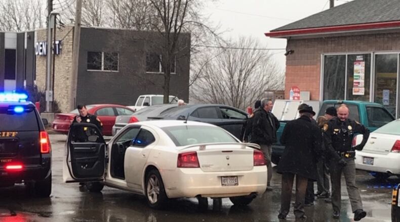 Clark County Sheriff ‘s Office deputies arrest a man in the area of Greenmont Avenue and East Main Street Thursday after a resident flags them down saying they saw someone in a car flashing a firearm.