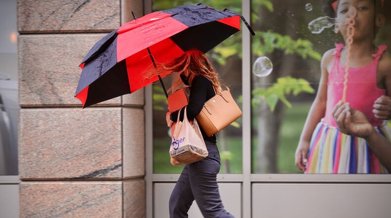 Another person tries to stay dry on this wet and windy Thursday morning on Second Street.