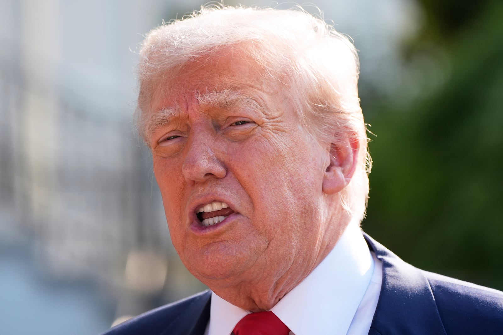 President Donald Trump speaks with reporters before departing on Marine One from the South Lawn of the White House, Friday, July 25, 2025, in Washington. The President is traveling to Scotland. (AP Photo/Alex Brandon)