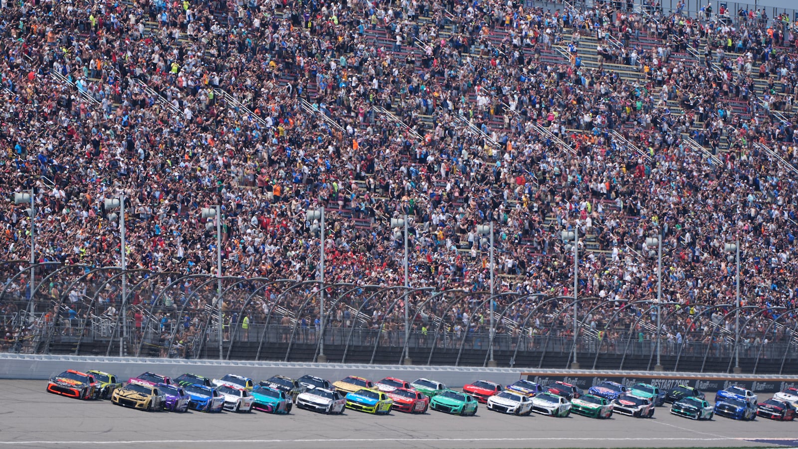 Pole sitter Chase Briscoe (19) leads the field to the start of a NASCAR Cup Series auto race at Michigan International Speedway in Brooklyn, Mich., Sunday, June 8, 2025. (AP Photo/Paul Sancya)