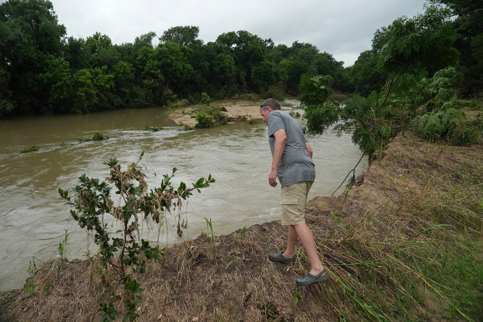 Jon Meredith, co-owner of Sweet Eats, looks over into the San Gabriel River following recent flooding Wednesday, July 9, 2025, near his farm in Georgetown, Texas. (AP Photo/Joshua A. Bickel)