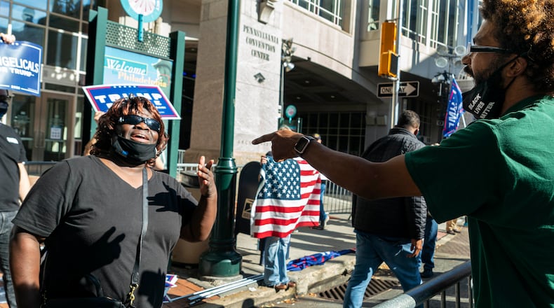 Daphne Goggins, 56, left, a supporter of President Donald Trump, and Daniel Gonzalez, 30, a supporter of Joe Biden, argue about the outcome of the election as they gather with other protesters outside the Philadelphia Convention Center in Philadelphia on Friday, Nov. 6, 2020. Joe Biden stood on the cusp of the presidency on Friday, seizing a lead over President Trump in both Pennsylvania and Georgia and drawing ever closer to securing the 270 electoral votes needed to lay claim to the White House. (Ruth Fremson/The New York Times)