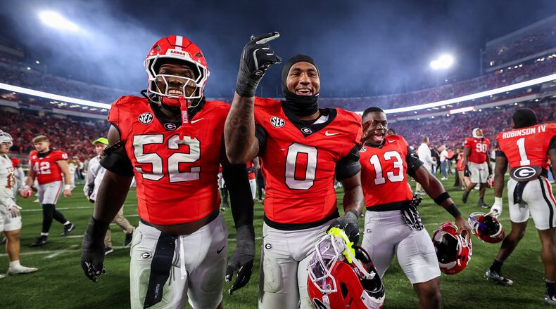 Georgia defensive lineman Christen Miller (52) and linebacker Gabe Harris Jr. (0) react after an NCAA college football game against Texas, Saturday, Nov. 15, 2025, in Athens, Ga. (AP Photo/Colin Hubbard)