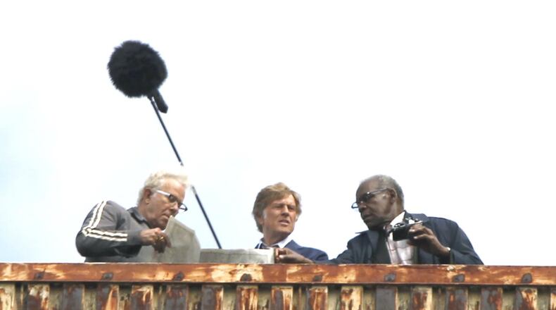 Scenes for the movie, “‘Old Man and the Gun,” were filmed in downtown Dayton Monday. The movie stars Robert Redford (center) and Danny Glover (right) as well as Casey Affleck and Sissy Spacek. Filming will continue in multiple locations Tuesday including the historic Liberty Savings Bank building on West Second Street. LISA POWELL / STAFF