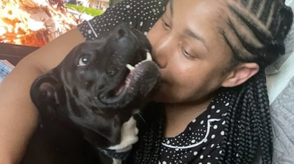 Zora, a pit bull, gives her mom Donelle a kiss. CONTRIBUTED