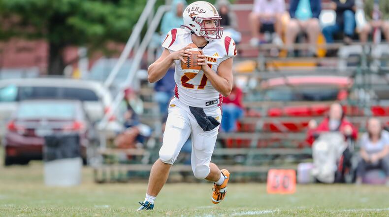 Northeastern High School junior Diezel Taylor rolls out to pass during their game against Catholic Central earlier this season at Hallinean Field in Springfield. CONTRIBUTED PHOTO BY MICHAEL COOPER