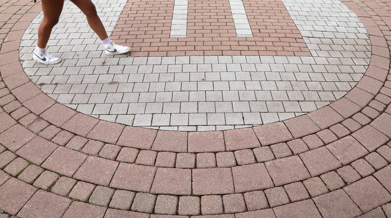 A student walks across campus at Wittenberg University last week. BILL LACKEY/STAFF