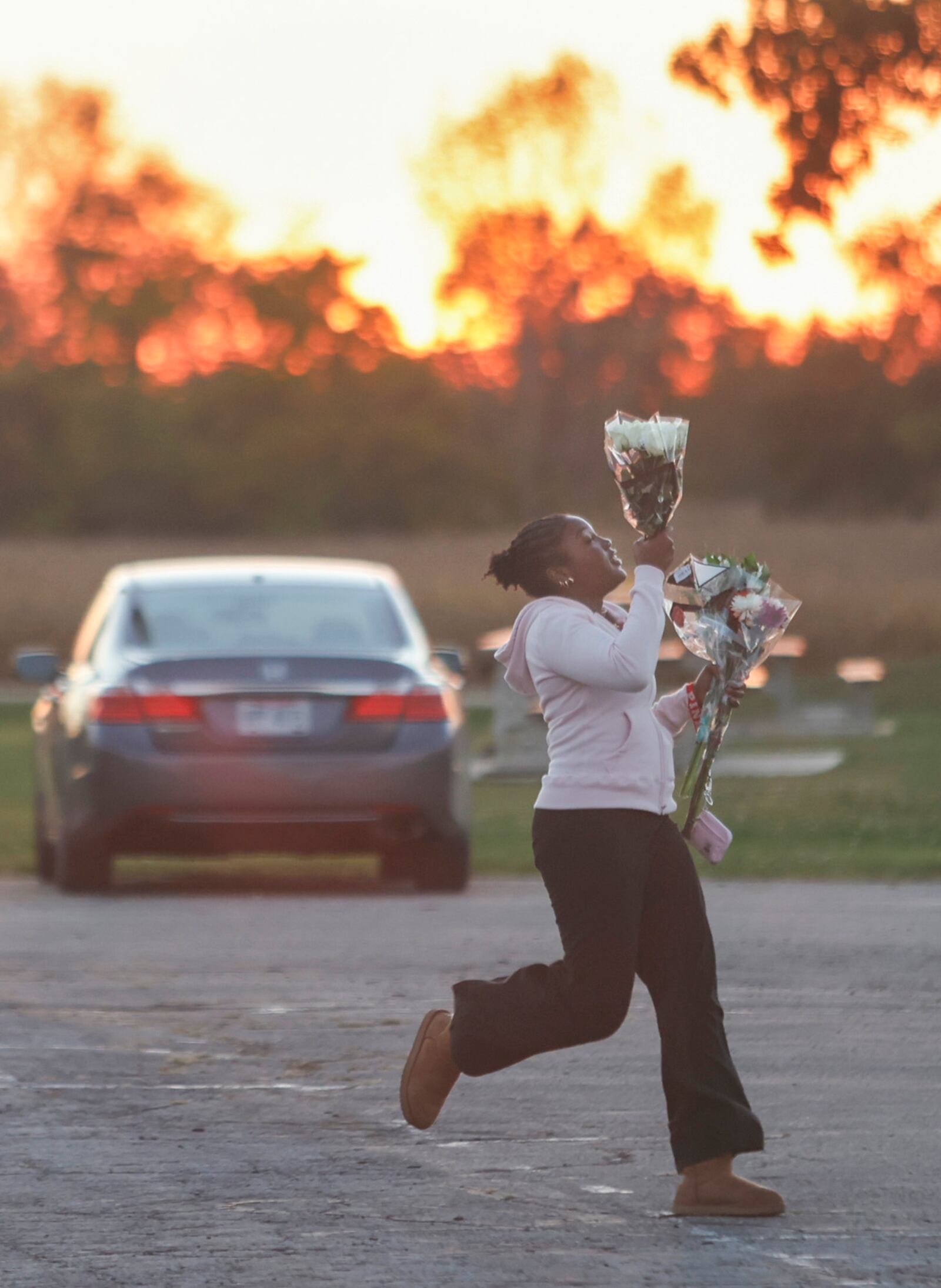 A student heads toward a candlelight vigil on Wednesday, October 8, 2025 at Greenon Stadium, to honor Greenon students Nevin Vince and Natalie Daly who were killed in a Huber Heights crash. The couple were killed in a head-on collision with a vehicle being driven the wrong way on I-70. JOSEPH COOKE / STAFF