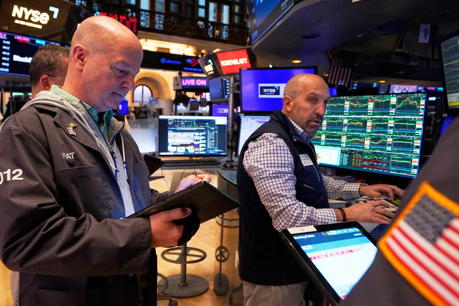 Trader Patrick Casey, left, and specialist Jamie Denaro work on the floor of the New York Stock Exchange, Friday, April 11, 2025. (AP Photo/Richard Drew)