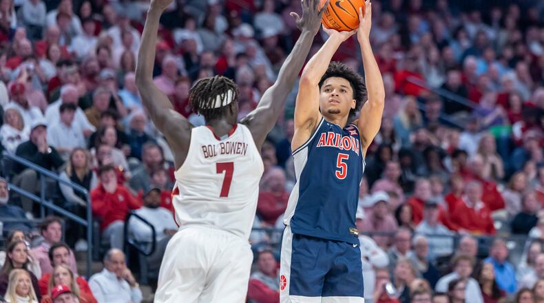 Alabama forward Amari Allen (5) shoots and hits a three-point shot over the defense of Alabama forward Taylor Bol Bowen (7) during the second half of an NCAA college basketball game, Saturday, Dec. 13, 2025, in Birmingham, Ala. (AP Photo/Vasha Hunt)