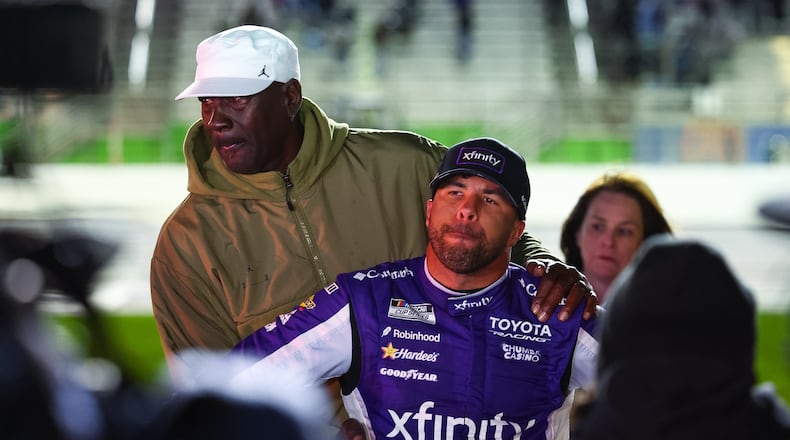 23XI Racing co-owner Michael Jordan, left, reacts with Bubba Wallace, right, after a NASCAR Cup Series auto race, Sunday, Feb. 22, 2026, in Hampton, Ga. (AP Photo/Colin Hubbard)
