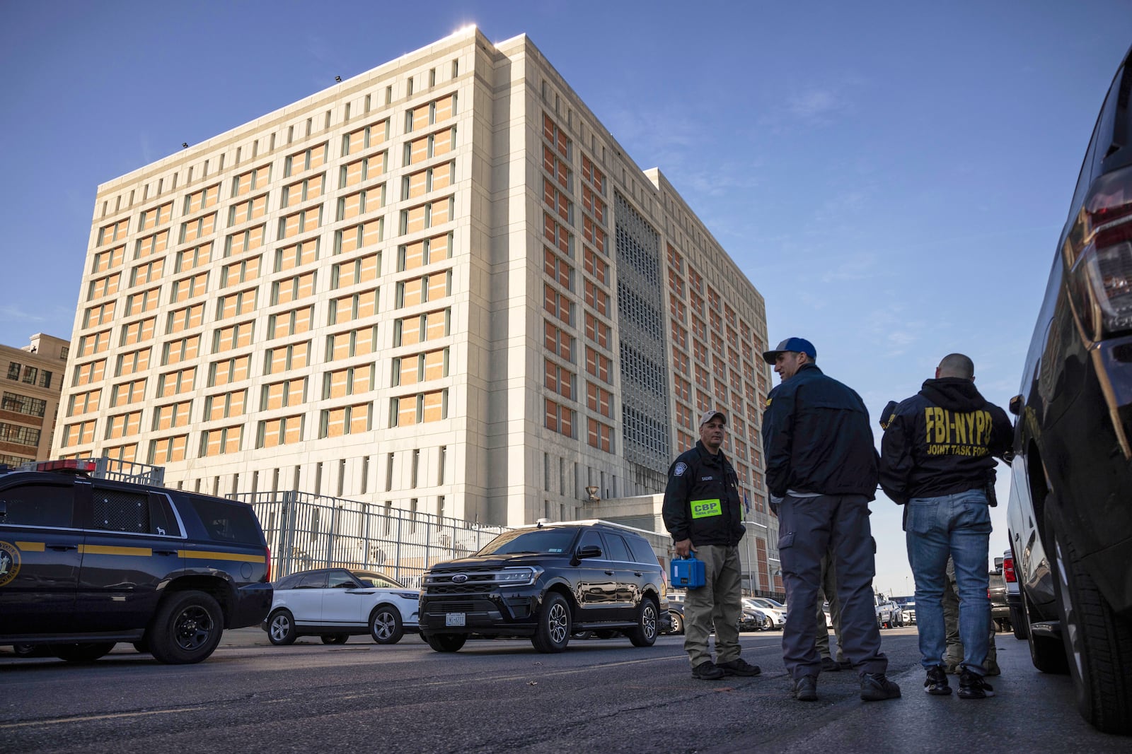 FILE - Federal enforcement officers stand outside the Metropolitan Detention Center, where Sean "Diddy" Combs is incarcerated on Oct. 28, 2024, in the Brooklyn Borough of New York. (AP Photo/Yuki Iwamura, File)