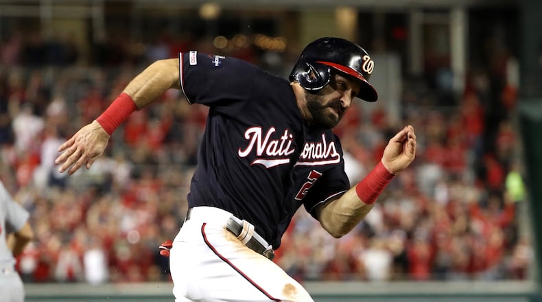 The Nationals' Adam Eaton runs home to score during the third inning of game three of the National League Championship Series against the St. Louis Cardinals at Nationals Park on October 14, 2019 in Washington, DC. (Photo by Patrick Smith/Getty Images)