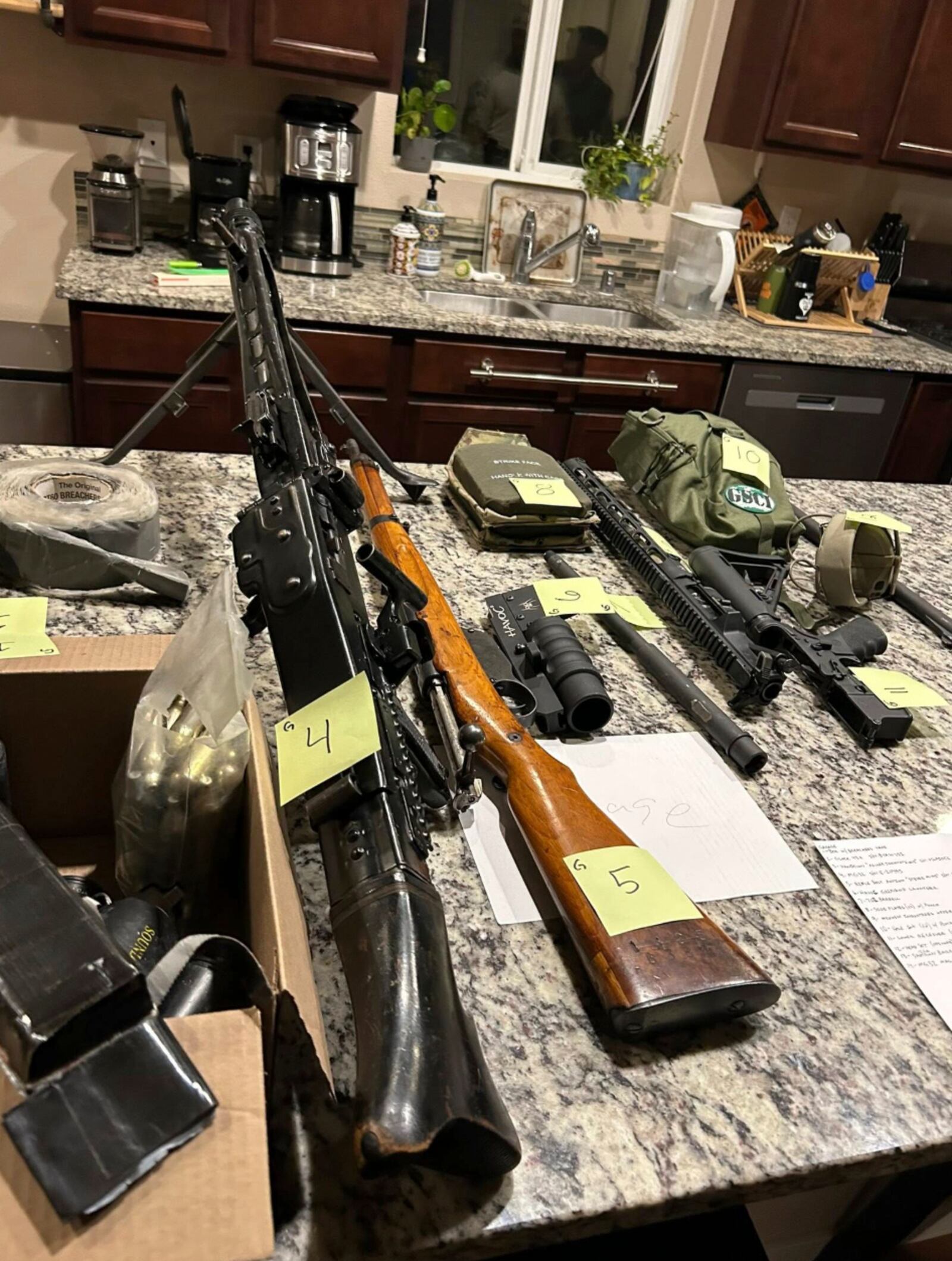 In this undated photo released by the Thurston County Sheriff's Office, a cache of military weaponry is displayed during a raid at a home in Lacey, Wash. (Thurston County Sheriff's Office via AP)