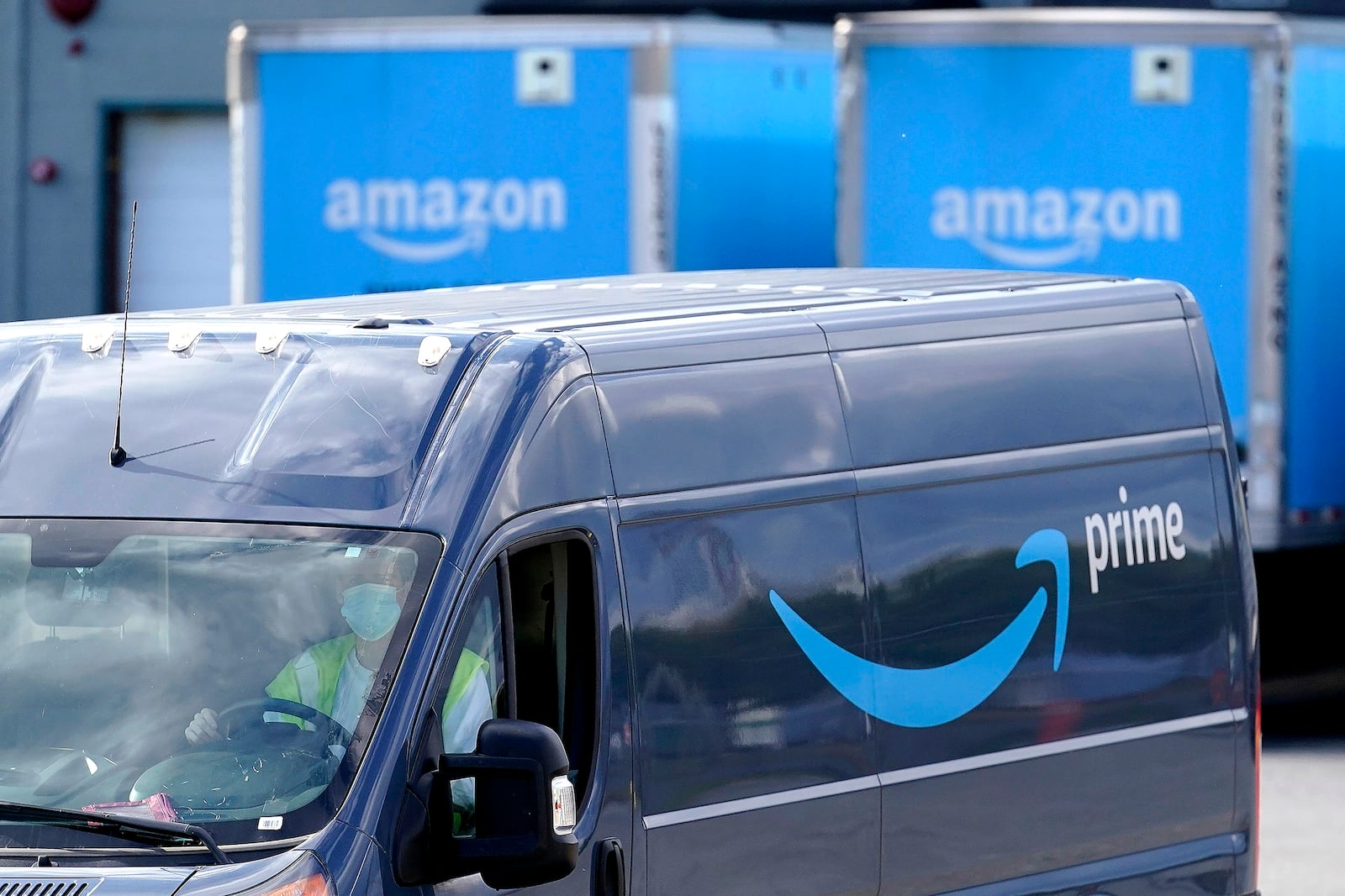 FILE - An Amazon Prime logo appears on the side of a delivery van as it departs an Amazon Warehouse location in Dedham, Mass., Oct. 1, 2020.   (AP Photo/Steven Senne, File)