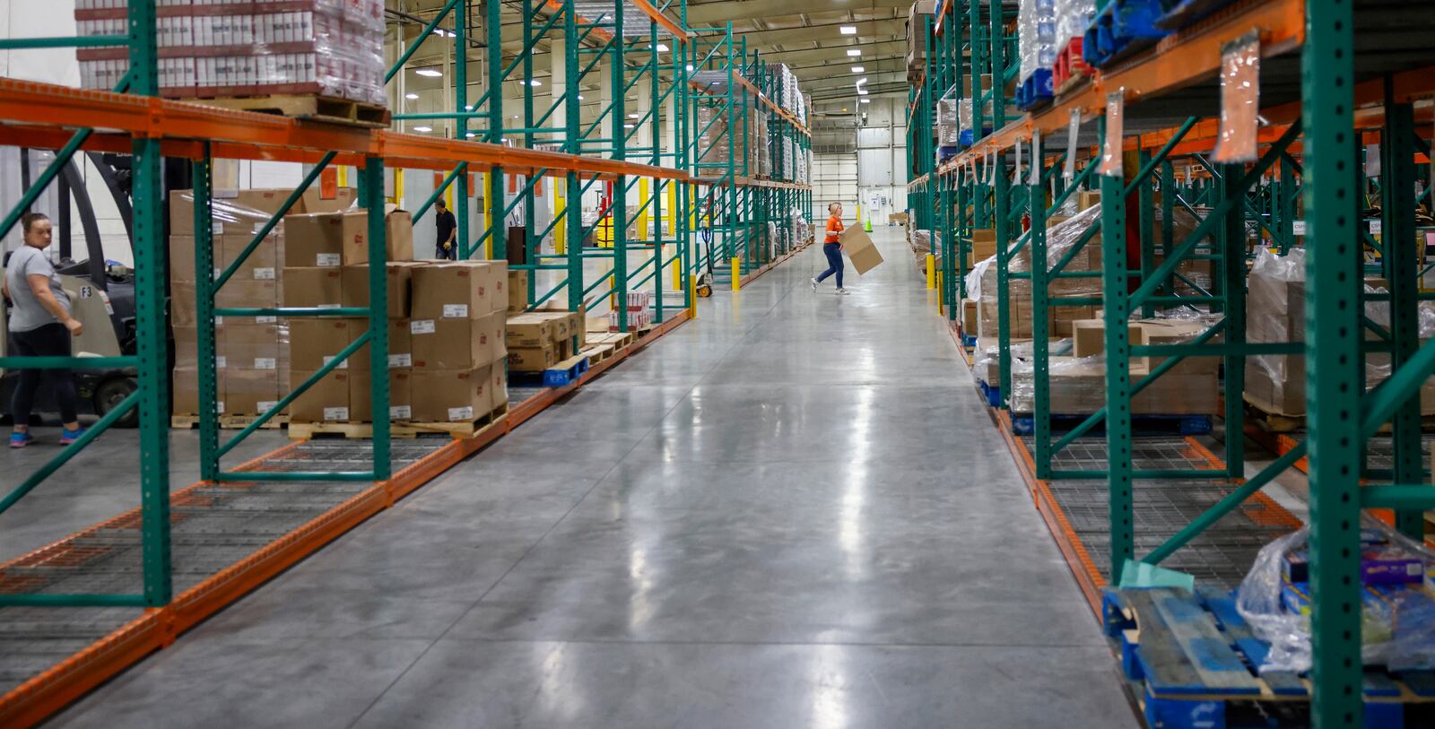 Maggie Yontz, program, agency and CSFP specialist of Second Harvest Food Bank, carries an empty box across the warehouse of Second Harvest Food Bank on Wednesday, July 9, 2025, in Springfield. JOSEPH COOKE/STAFF