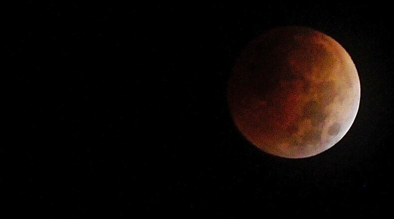 The second total lunar eclipse of the year took place Tuesday morning on Nov. 8, 2022. It's the last total lunar eclipse for the next three years. The light from the Earth's sunset and sunrise can give the moon a reddish-orange appearance, prompting the nickname "blood moon". MARSHALL GORBY / STAFF