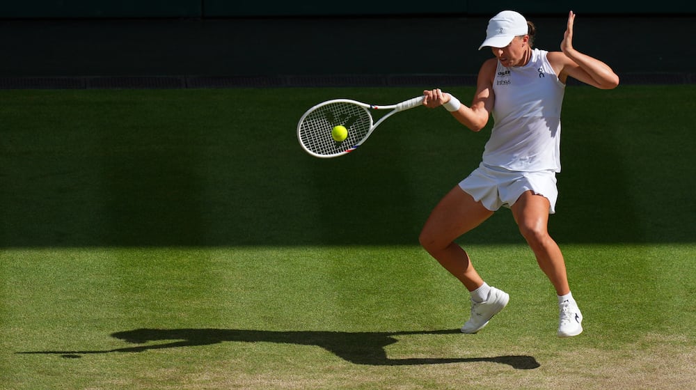 FILE -Iga Swiatek of Poland returns to Amanda Anisimova of the U.S. during the women's singles final match at the Wimbledon Tennis Championships in London, July 12, 2025.(AP Photo/Joanna Chan, File)