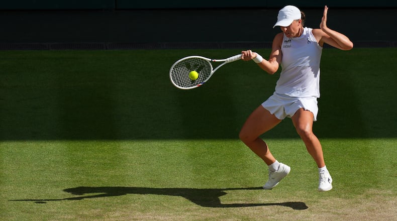 FILE -Iga Swiatek of Poland returns to Amanda Anisimova of the U.S. during the women's singles final match at the Wimbledon Tennis Championships in London, July 12, 2025.(AP Photo/Joanna Chan, File)