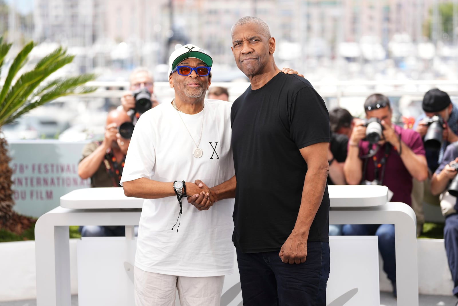Director Spike Lee, left, and Denzel Washington pose for photographers at the photo call for the film 'Highest 2 Lowest' at the 78th international film festival, Cannes, southern France, Monday, May 19, 2025. (Photo by Scott A Garfitt/Invision/AP)