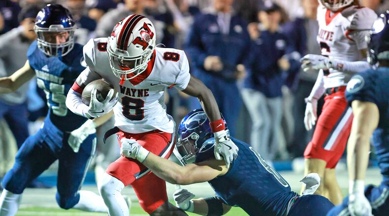 Wayne's Jamier Averette-Brown avoids a tackle by Fairmont's Skyler Slifer during round two of the playoffs Friday, Nov. 8, 2024. BILL LACKEY/STAFF