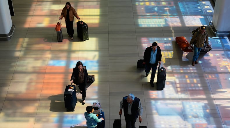 Stained-glass windows cast colorful shadows at LaGuardia Airport in New York, Monday, March 30, 2026. (AP Photo/Seth Wenig)