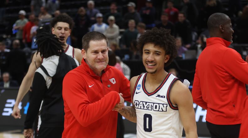 Dayton's Darren Hertz and Javon Bennett celebrate after a victory against Nevada in the first round of the NCAA tournament on Thursday, March 21, 2024, at the Delta Center in Salt Lake City, Utah. David Jablonski/Staff