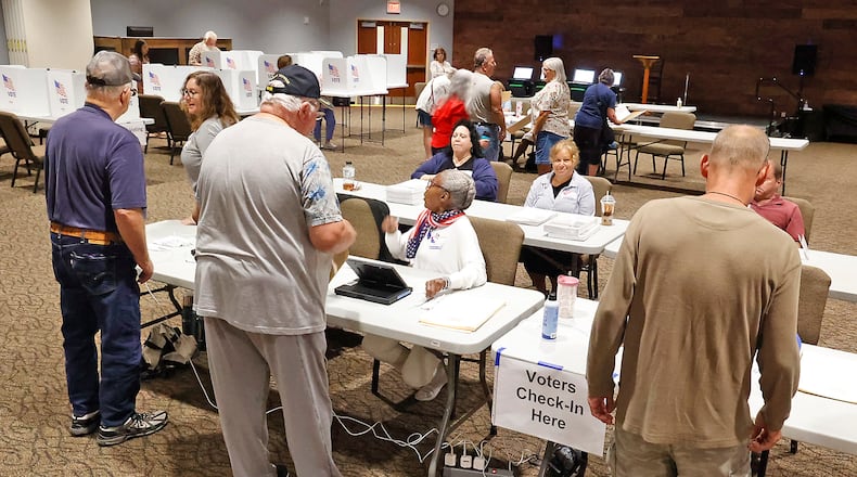 People check-in at the election poll at the First Christian Church in Springfield Tuesday, August 8, 2023. BILL LACKEY/STAFF