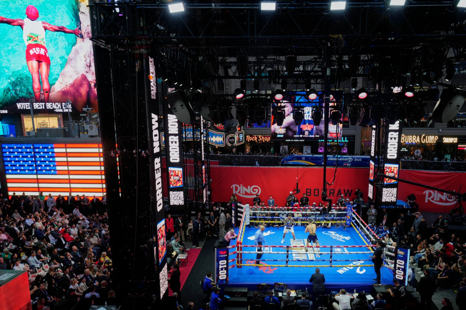 Fans watch Teofimo Lopez and Arnold Barboza Jr. fight during a super lightweight boxing match in Times Square Friday, May 2, 2025, in New York. (AP Photo/Frank Franklin II)