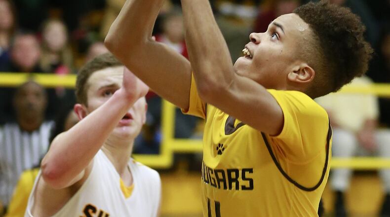 Kenton Ridge’s Jameel Cosby goes up for two points under pressure from Shawnee’s Billy Lord. BILL LACKEY / STAFF