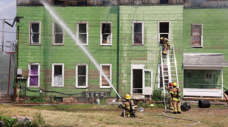 The Springfield Fire Division battled a fire in a two story apartment house on Mulberry Street Friday, June 9, 2023. At least four residents lost their home in the blaze and Red Cross was called to assist them. The fire division arrived to find flames coming through the roof. According to Assistant Fire Chief Matt Smith, the stairs had already collapsed so they started attacking the fire from the outside. The building is a total loss. BILL LACKEY/STAFF