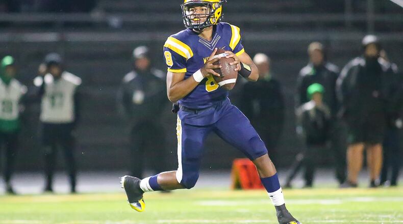 Springfield High School senior quarterback Te'Sean Smoot rolls out to pass during their game against Northmont on Friday night at Springfield High School. Smoot had six total TDs as the Wildcats beat the Thunderbolts 42-7. Michael Cooper/CONTRIBUTED