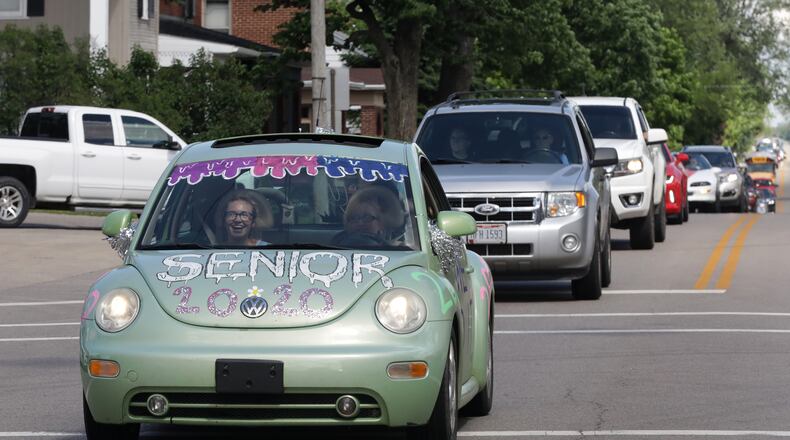 Graduating seniors at Graham High School participate in a graduation parade through St. Paris in May. The seniors were led by a Champaign County Sheriff's cruiser as they traveled from St. Paris to Christiansburg and around to all the small towns in the school district. BILL LACKEY/STAFF