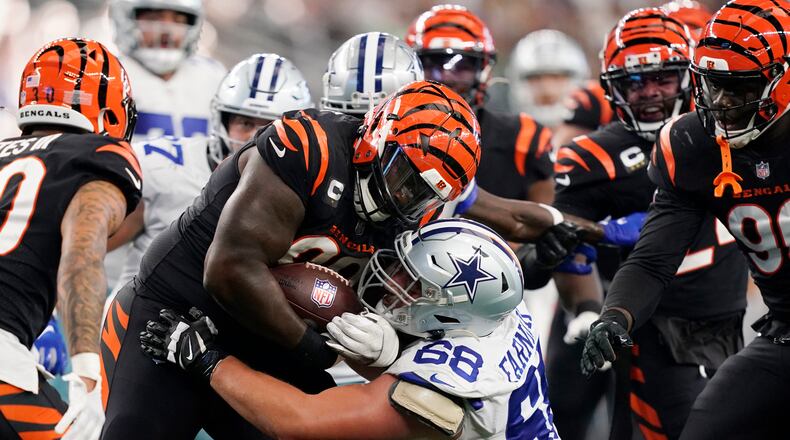 Cincinnati Bengals defensive tackle DJ Reader (98) advances the ball after a fumble recovery as Dallas Cowboys guard Matt Farniok (68) makes the stop during the second half of an NFL football game Sunday, Sept. 18, 2022, in Arlington, Tx. (AP Photo/Tony Gutierrez)