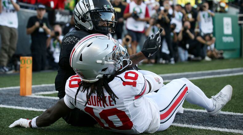 Oregon wide receiver Evan Stewart, top, celebrates after a touchdown against Ohio State cornerback Denzel Burke (10) during an NCAA college football game, Saturday, Oct. 12, 2024, in Eugene, Ore. (AP Photo/Lydia Ely)