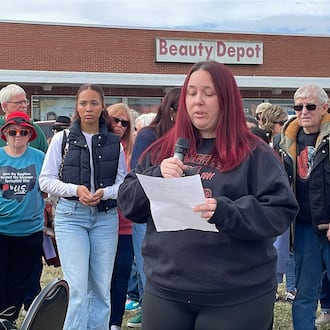 Lacy Arriaga, 37, of Springfield, (center) speaks during a press conference Saturday outside of the Southgate shopping center in Springfield. Local advocates gathered to show support for her family as her husband, Juan Arriaga Reyes, 45, was recently detained by U.S. Immigration and Customs Enforcement (ICE) following his annual check-in with the agency. He is being held at the Butler County Correctional Complex and is expected to be deported back to Mexico soon. SAM WILDOW/STAFF