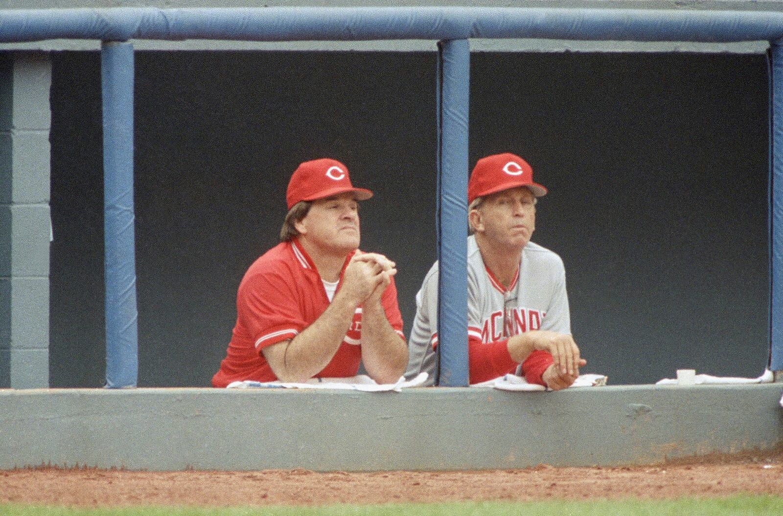 FILE - Cincinnati Reds manager Pete Rose, left, and coach Tommy Helms watch from the dugout, June 21, 1989 as the Reds and Atlanta Braves play in Atlanta. (AP Photo/John Bazemore, File)