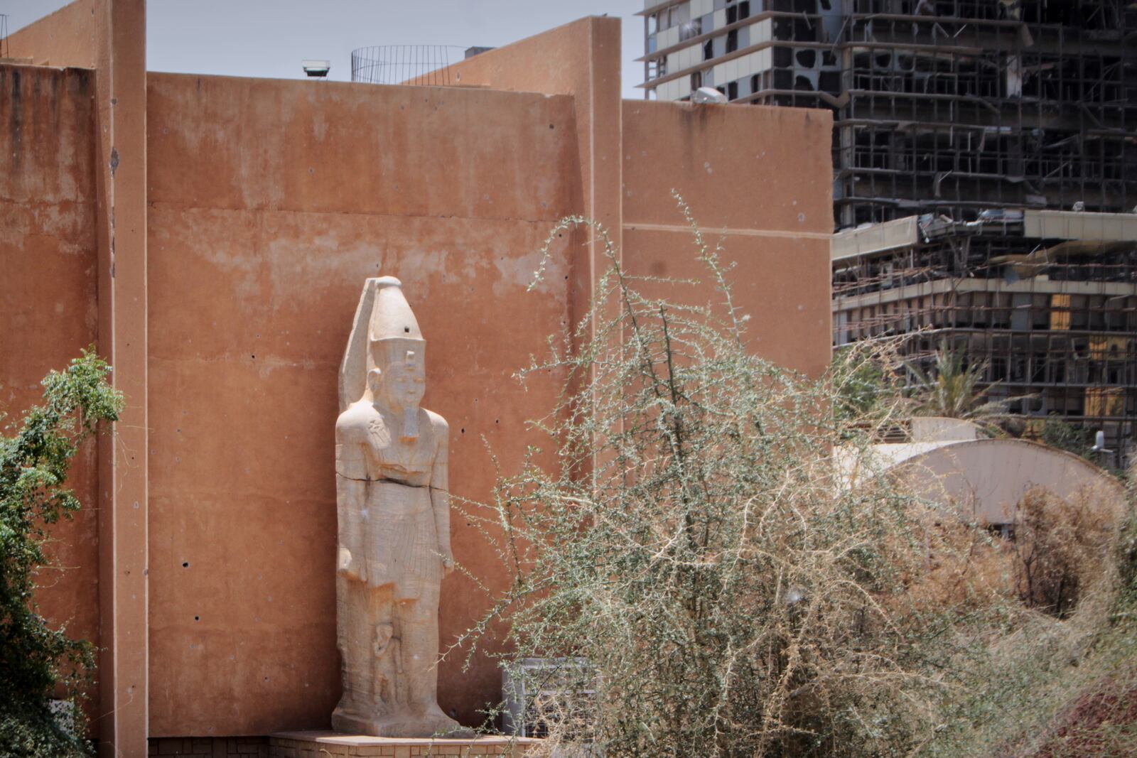 A granite colossal statue from the ancient temple of Tabo on Argo Island stands despite the damage at the Sudan National Museum, the home to the country's largest artifacts that date to different eras of Sudanese history, after nearly two years of war between the army and paramilitary Rapid Support Forces (RSF), in Khartoum, Sudan, Thursday, April 3, 2025. (AP Photo/Khaled Abd Al Gader)