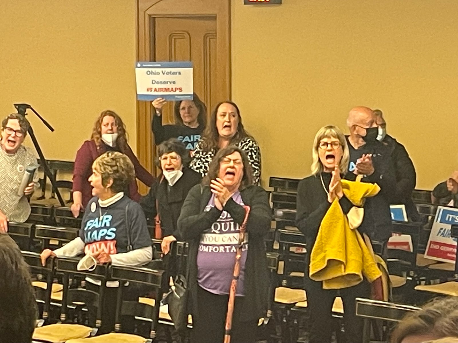 Audience members at the Ohio Redistricting Commission meeting May 4, 2022, chant "Fair maps now!" after the commission adjourned without action.