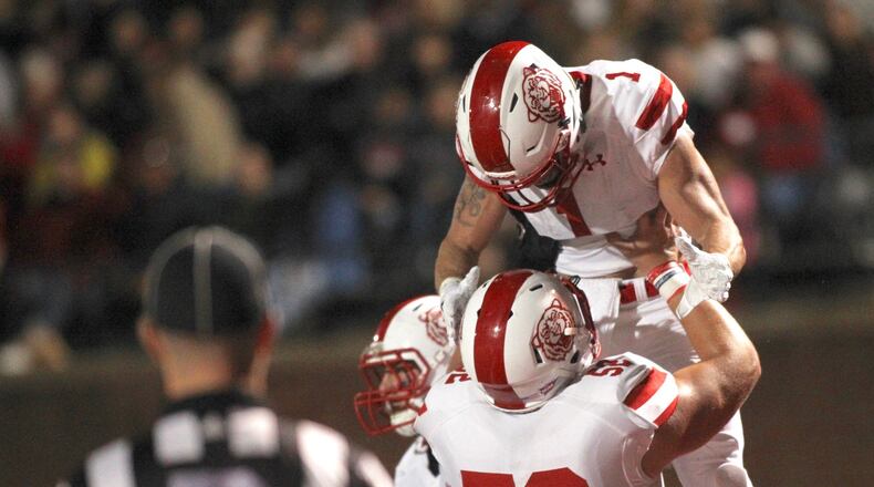 Wittenberg’s Jeff Tiffner (1) celebrates a touchdown with Tommy Gerhard against Denison on Saturday, Sept. 29, 2018, at Deeds Field in Granville. David Jablonski/Staff David Jablonski/Staff