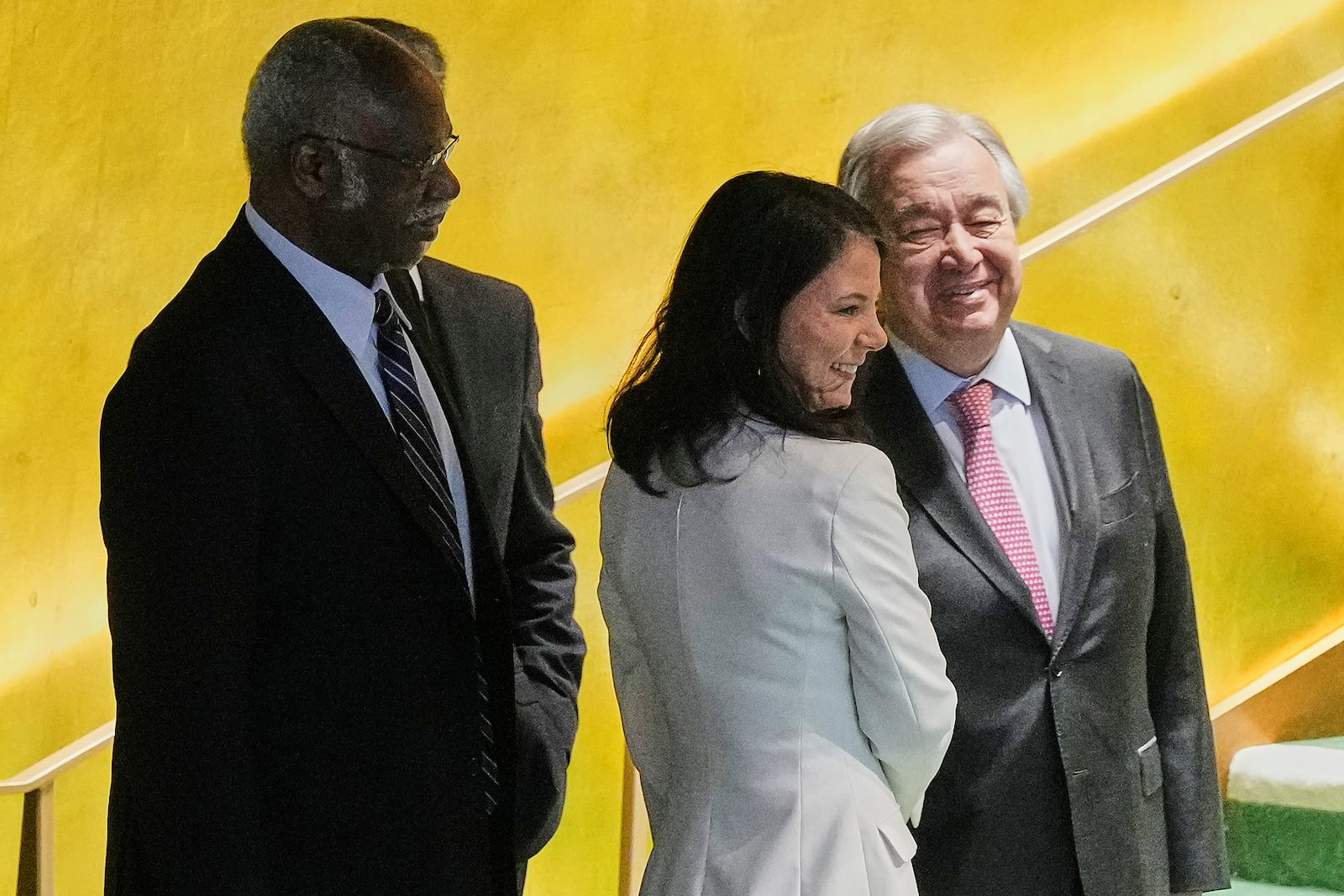 Annalena Baerbock of Germany, center, is greeted by UN Secretary General Antonio Guterres, right, and current UNGA President Philemon Yang, left, after she was elected as president of the 80th session of the UN General Assembly, Monday, June 2, 2025. (AP Photo/Richard Drew)