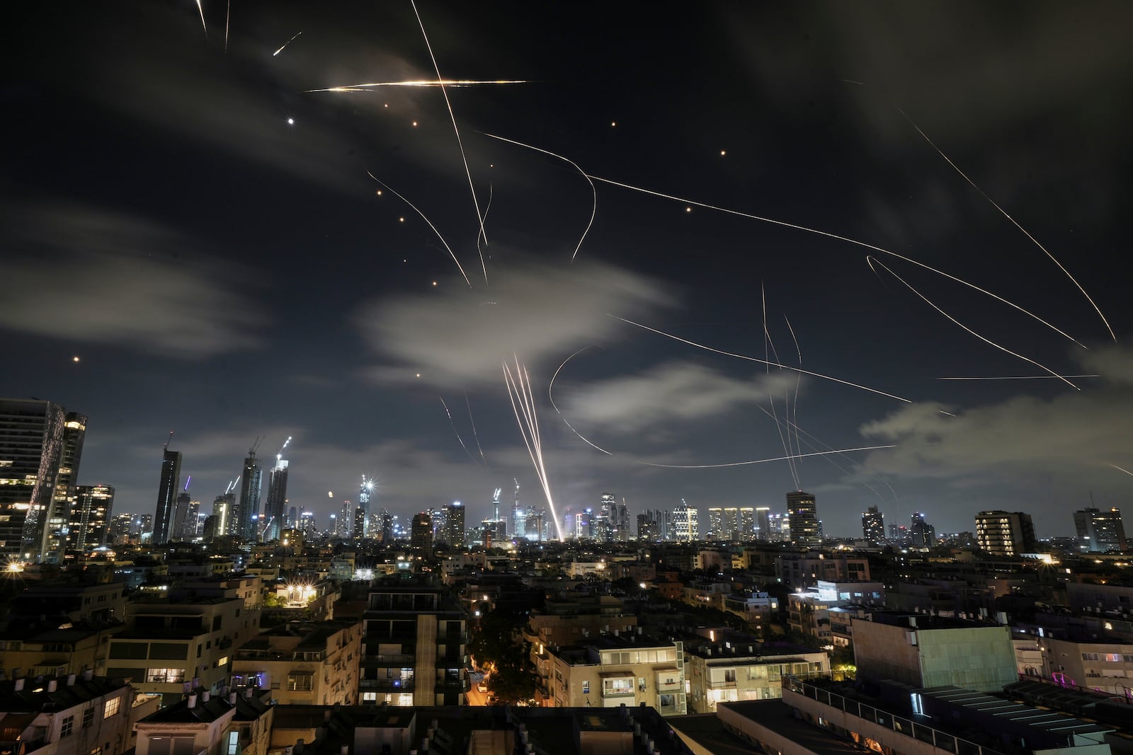 The Israeli Iron Dome air defense system fires to intercept missiles during an Iranian attack over Tel Aviv, Israel, early Wednesday, June 18, 2025. (AP Photo/Leo Correa)